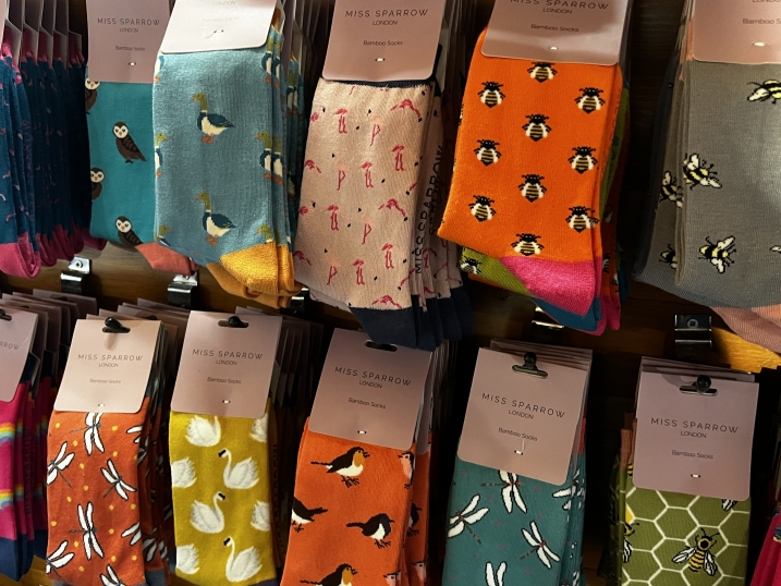 Socks on display at WWT Martin Mere gift shop. In this photo includes bee, dragonfly, swan, robin, owl, and flamingo socks.